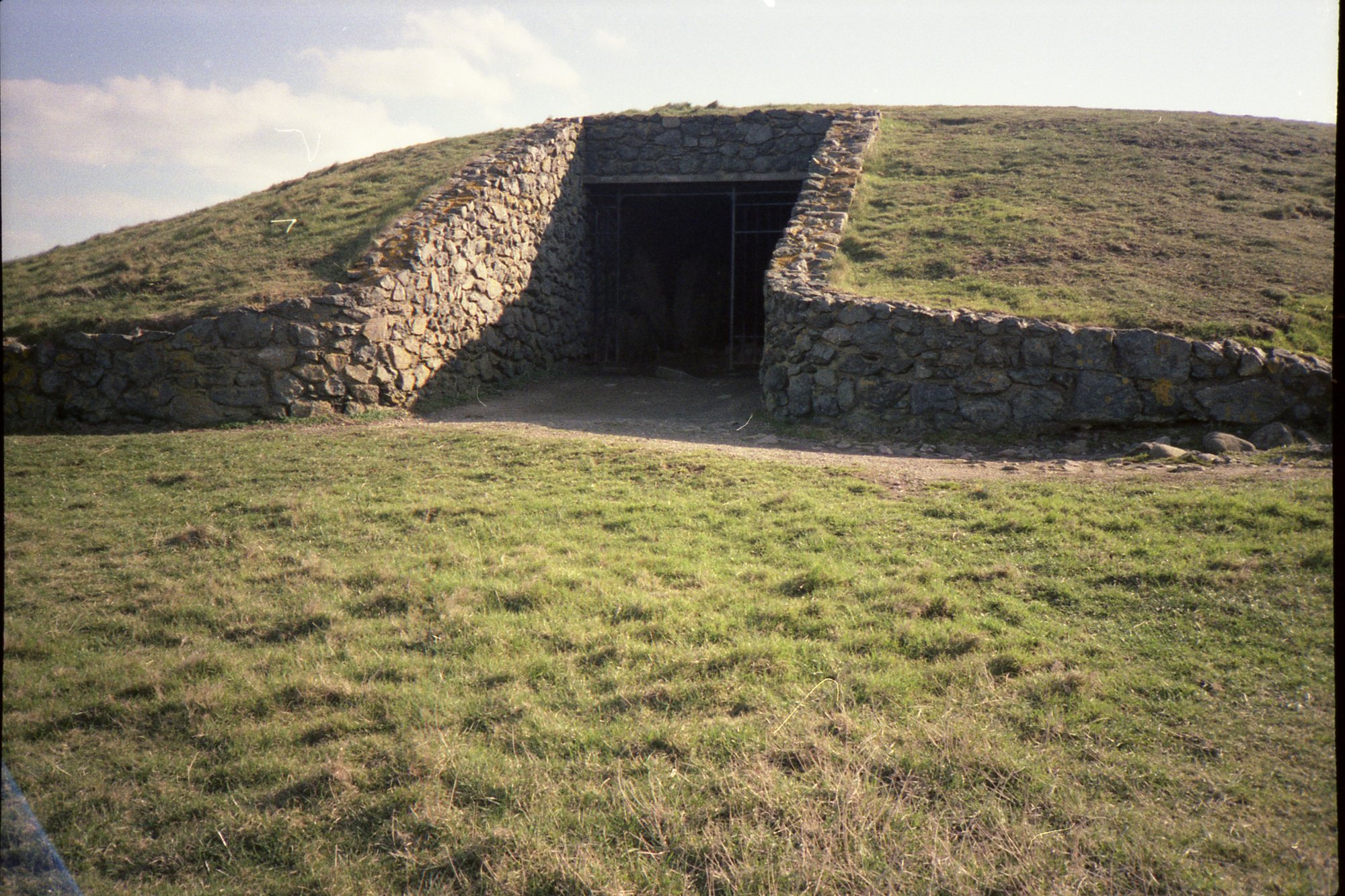Barclodiad y Gawres above Porth Trecastell