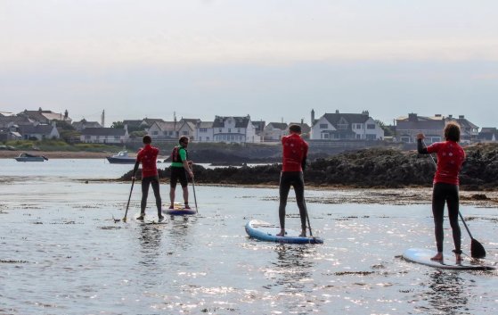 Stand-up paddleboarders near Rhosneigr